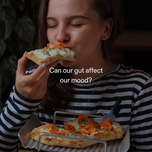 Woman enjoying healthy pizza – linking gut-brain connection, mood, and GLP-1-related appetite signals