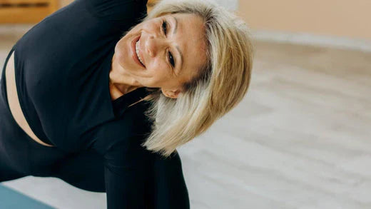 Active middle-aged woman stretching during yoga session for healthy aging and wellness