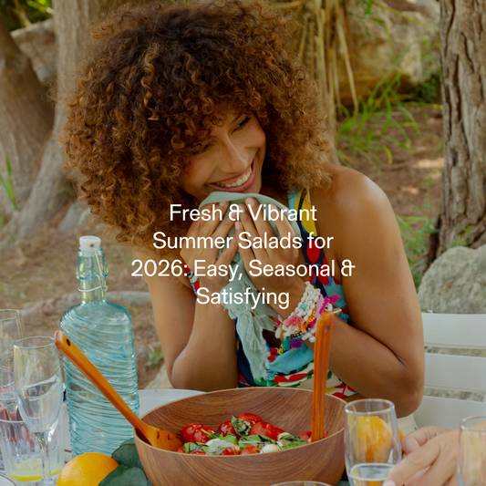 Colourful summer salad bowls with fresh stone fruit, avocado, corn, and herbs on a bright outdoor table for light seasonal eating