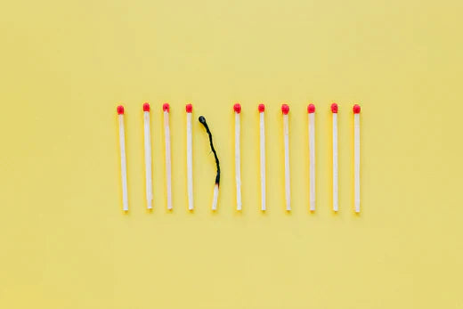 Burnout concept with a line of matchsticks, symbolizing stress and health challenges
