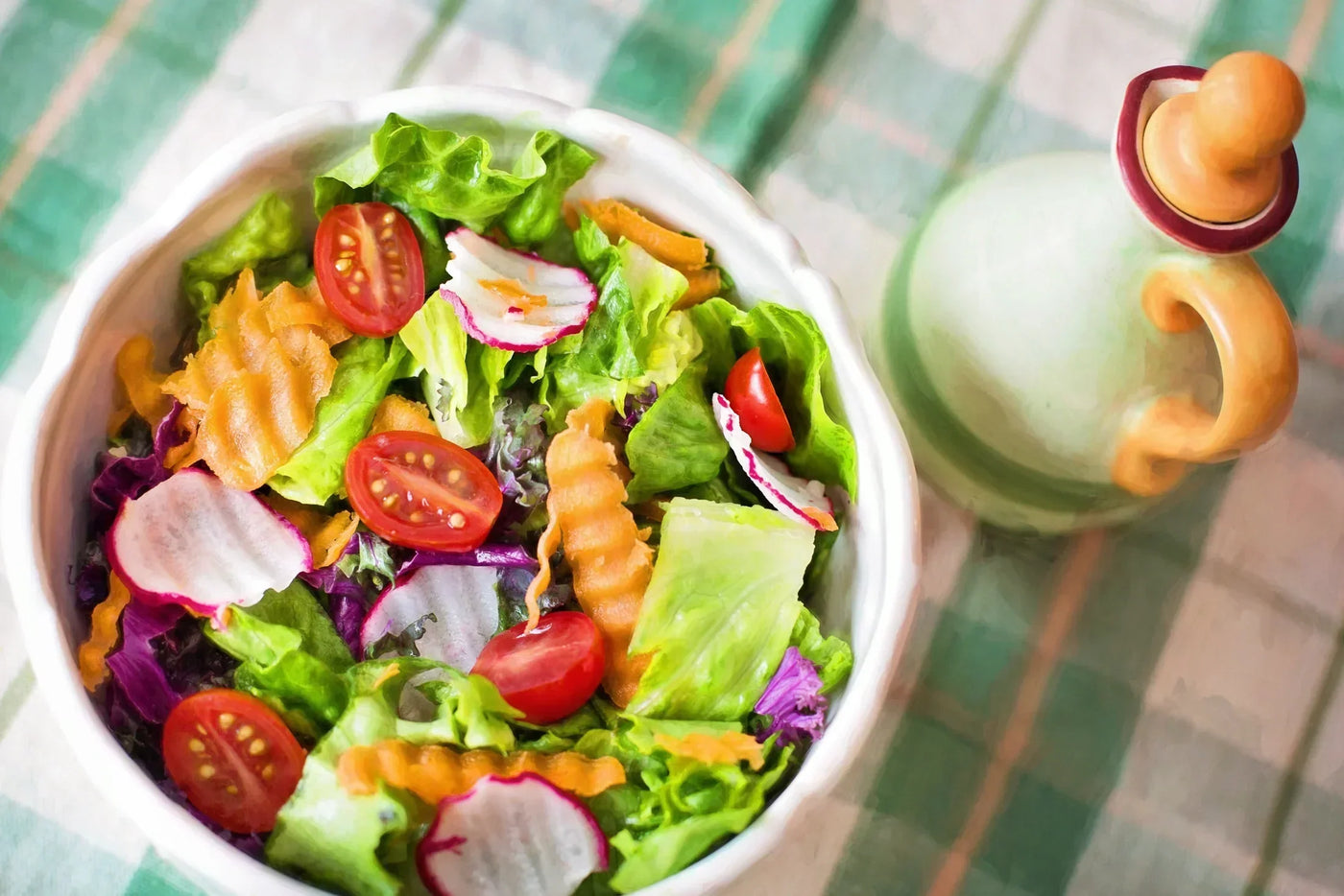 Colorful fresh vegetable salad with cherry tomatoes, radishes, and leafy greens in a bowl