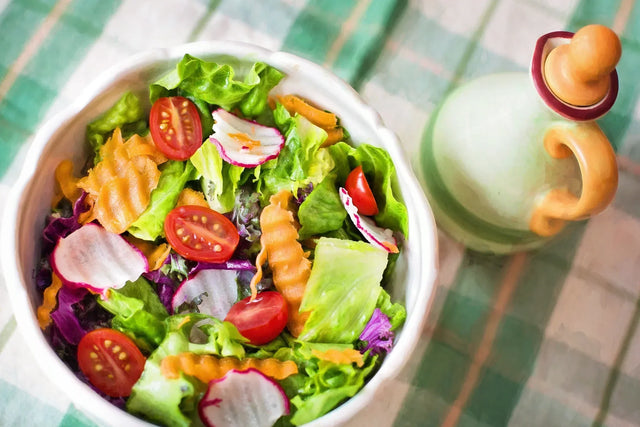 Colorful fresh vegetable salad with cherry tomatoes, radishes, and leafy greens in a bowl