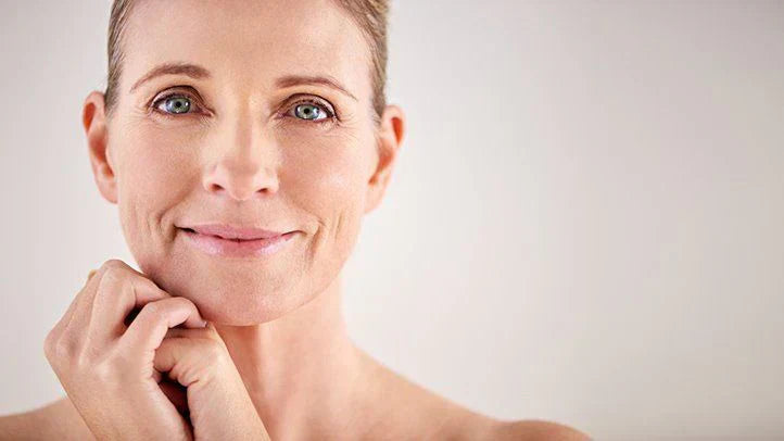 Confident middle-aged woman with smooth, radiant skin showing healthy aging and skincare results