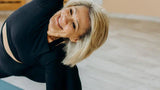 Active middle-aged woman stretching during yoga session for healthy aging and wellness