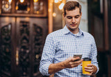 Man holding coffee and phone during intermittent fasting routine