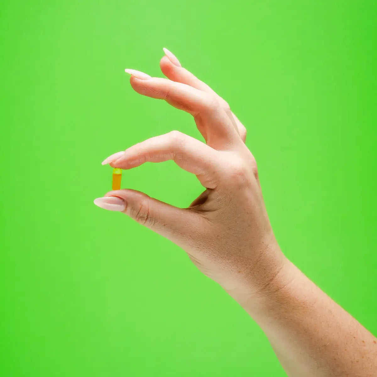 Hand holding Calocurb capsule – natural appetite suppressant and plant-based GLP-1 supplement